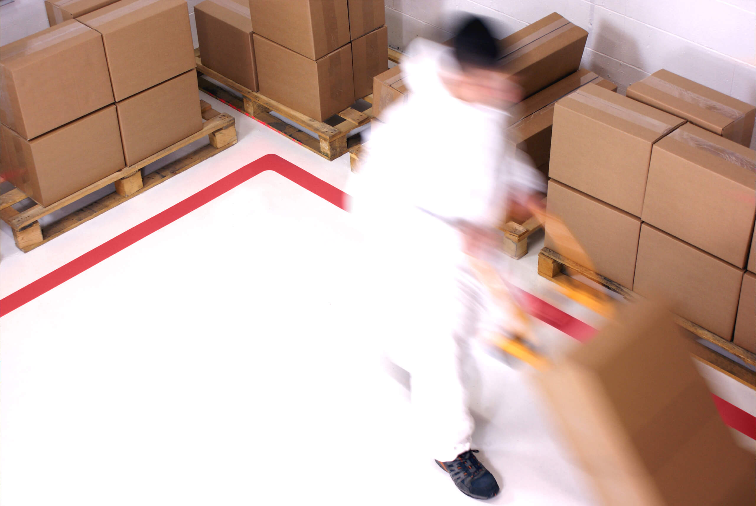 PermaRoute Line Marking Tape in a Warehouse with Man Pushing Truck PermaRoute Line Marking Tape in a Warehouse with Man Pushing Truck